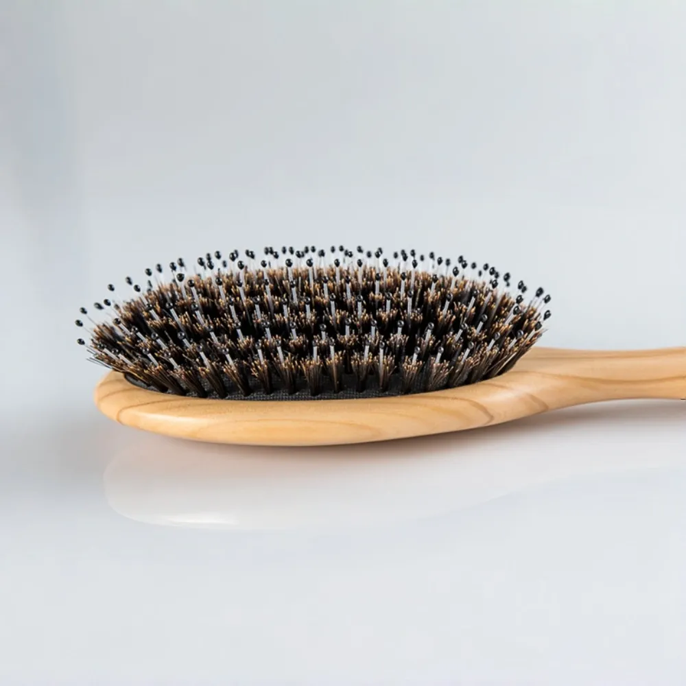 Close-up view of BSFL professional natural pig bristle hair brush for superior styling.