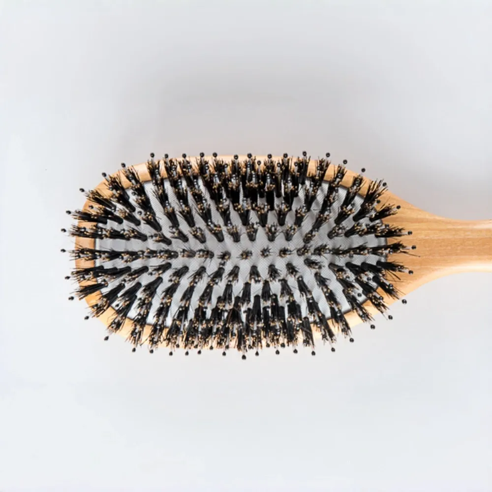 Top view of BSFL ergonomic hair brush designed for gentle scalp massage.